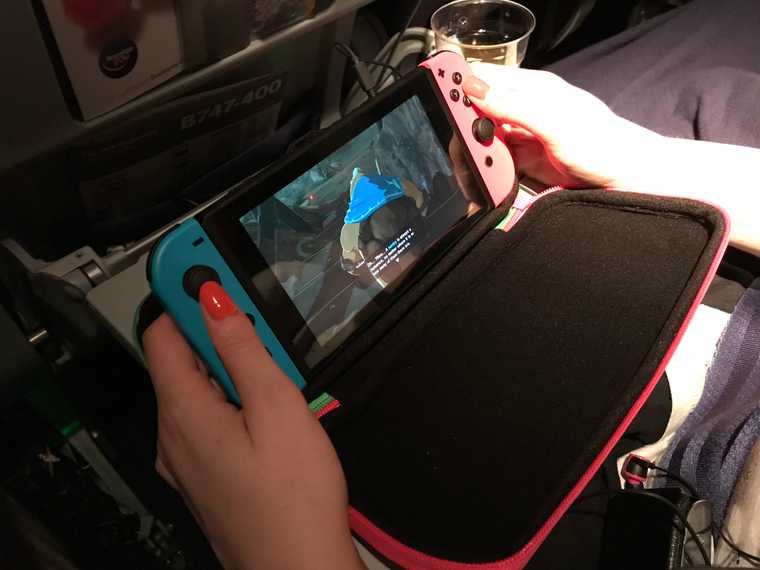A young woman playing Zelda: Breath of the Wild on Nintendo Switch