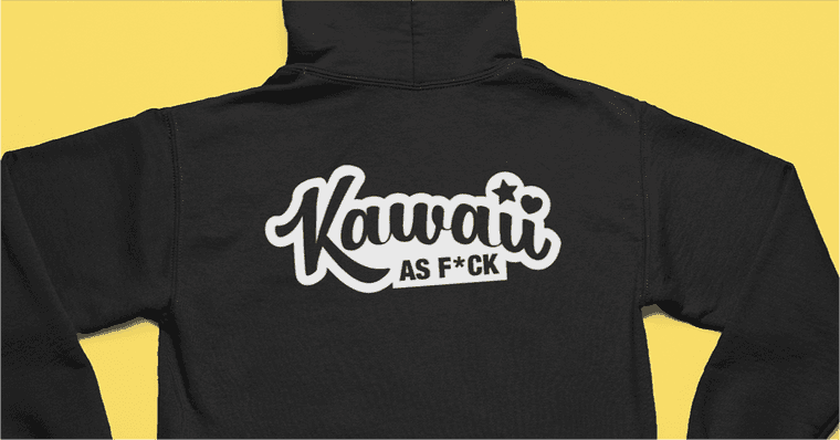 "Back of a black hooded sweater on yellow background. Logo in white with cursive typeface reads Kawaii as F*ck."