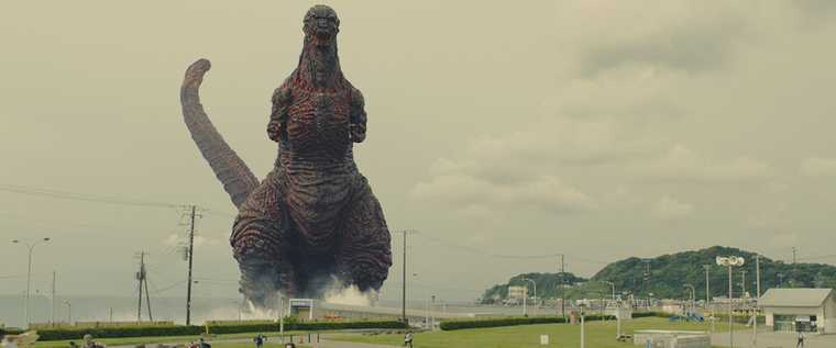 Godzilla emerges on land from the Japanese coastline