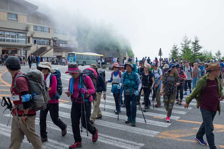 A group of hikers crossing the road at the 5th station of Mt Fuji