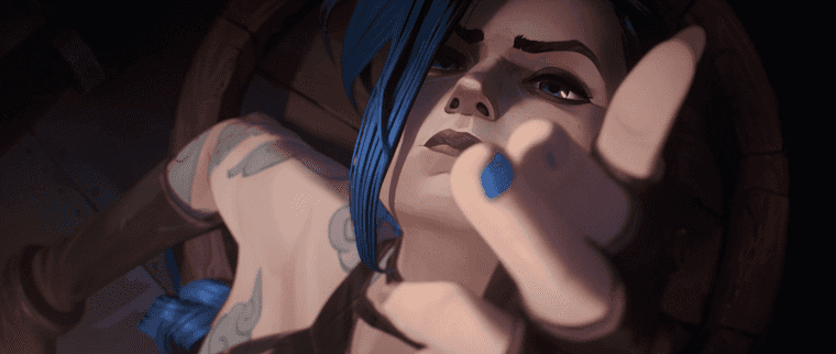 "Screen from Arcane. A young blue haired girl (Jinx) points two fingers towards the camera in a shooting gesture."