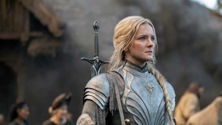 "Screen from The Lord of the Rings: The Rings of Power TV show. Galadriel played by Morfydd Clark wearing armour and staring intensely."