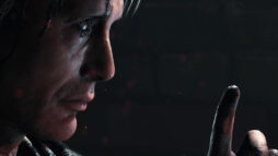 Promotional image from Death Stranding. Mads Mikkelsen's character raising his finger to his lips.