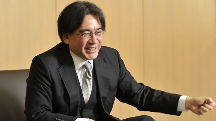 Photography of Japanese game developer, Satoru Iwata, wearing a suit.