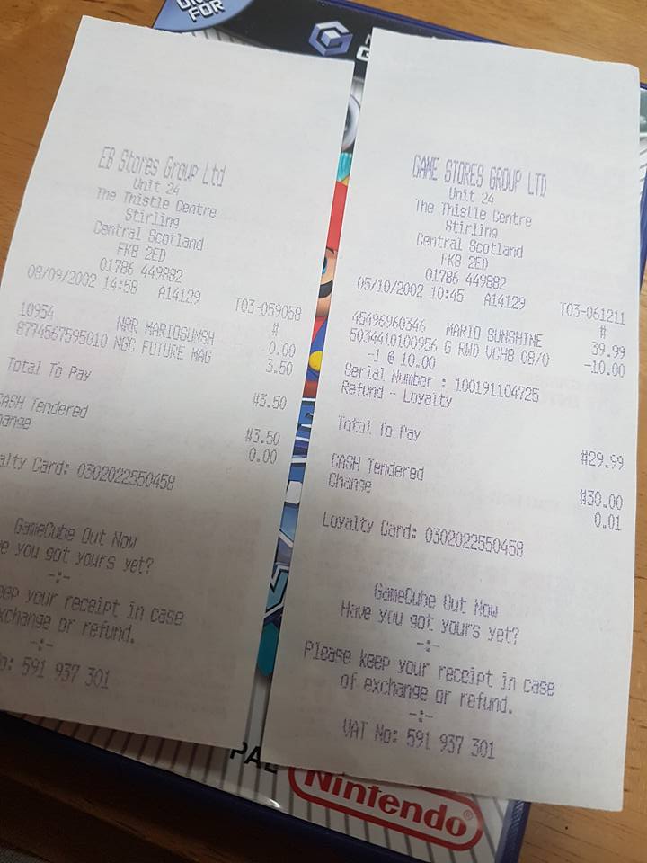 Various receipts for games purchased at Game Stores Group Ltd on top of Mario Sunshine for Gamecube box.