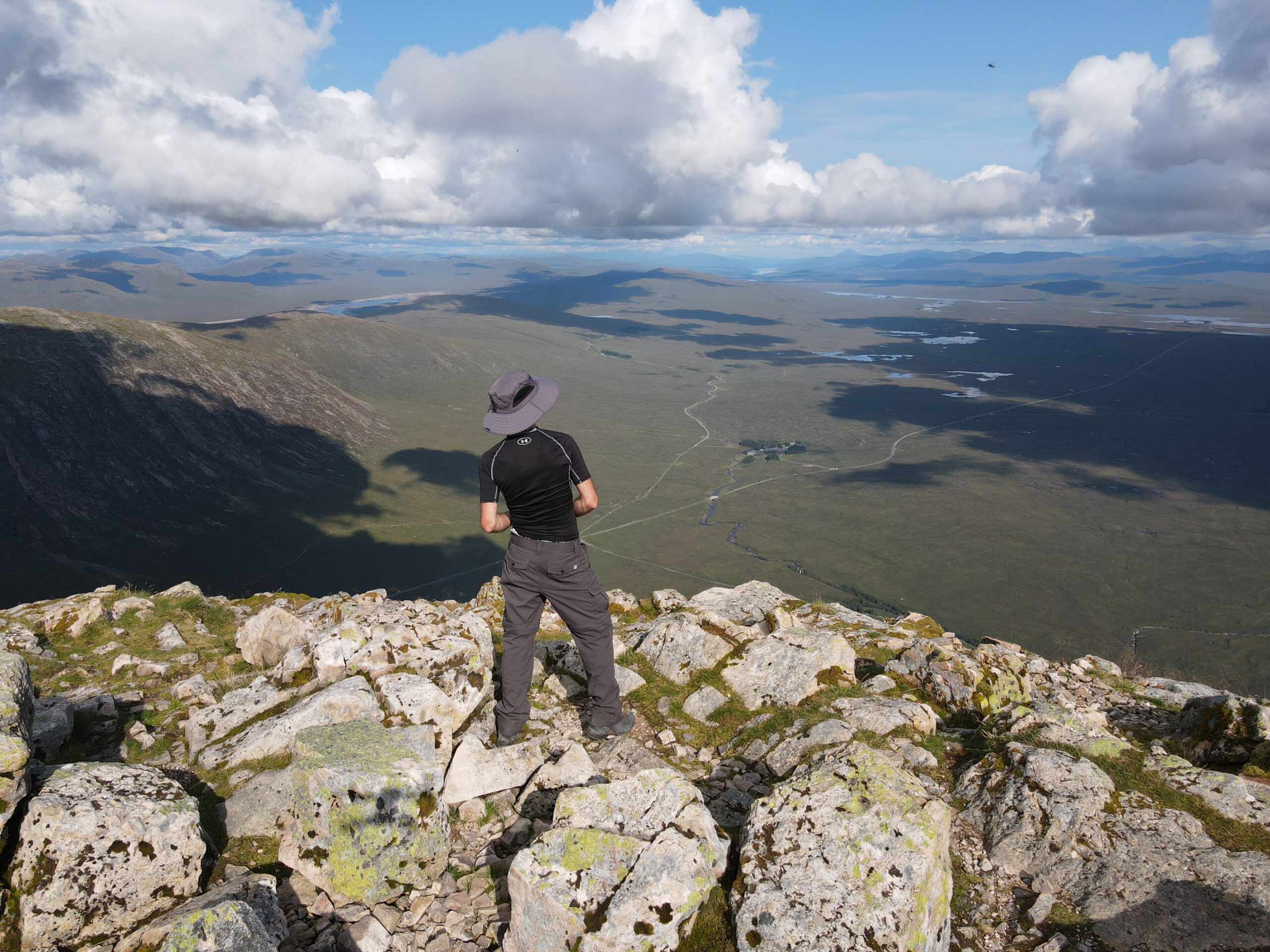 A man looking over Rannoch Moor from the top of Stob Dearg, Buachaille Etive Mòr