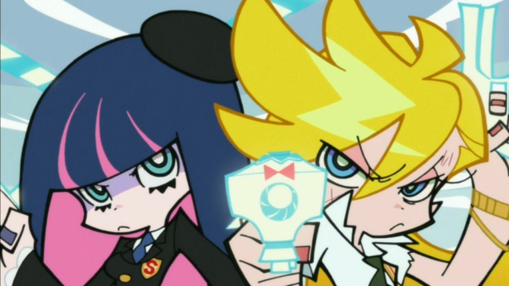 Screen from animation "Panty and Stocking". Blond woman (Panty) points her gun towards the camera and blue and pink haired woman (Stocking) stands beside her pouting.