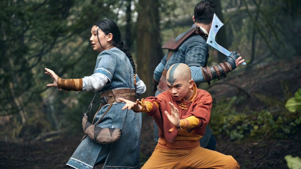 Screen from Netflix' Avatar: The Last Airbender series. 3 young heroes stand in a defensive formation.