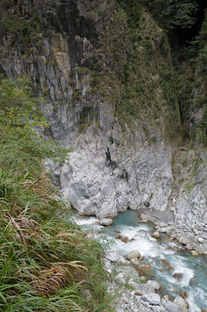 Taroko National Park in January 2024. Looking down into a river running through a gorge. Vegetation in the foreground.