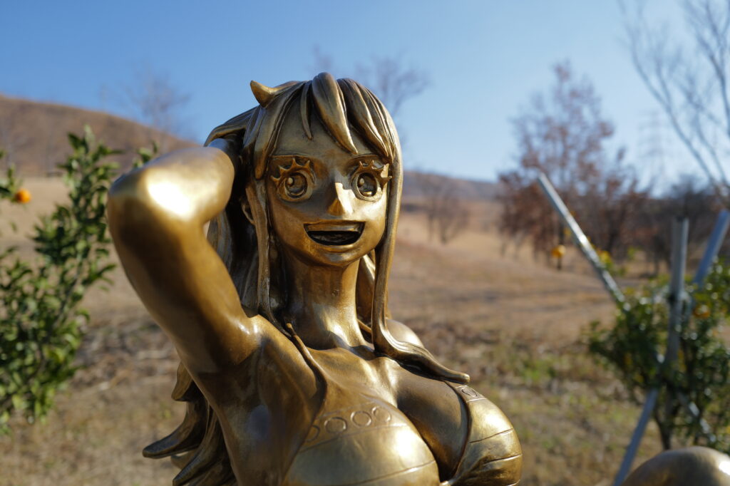 Bronze nami statue in Kumamoto, running her hand through her hair.